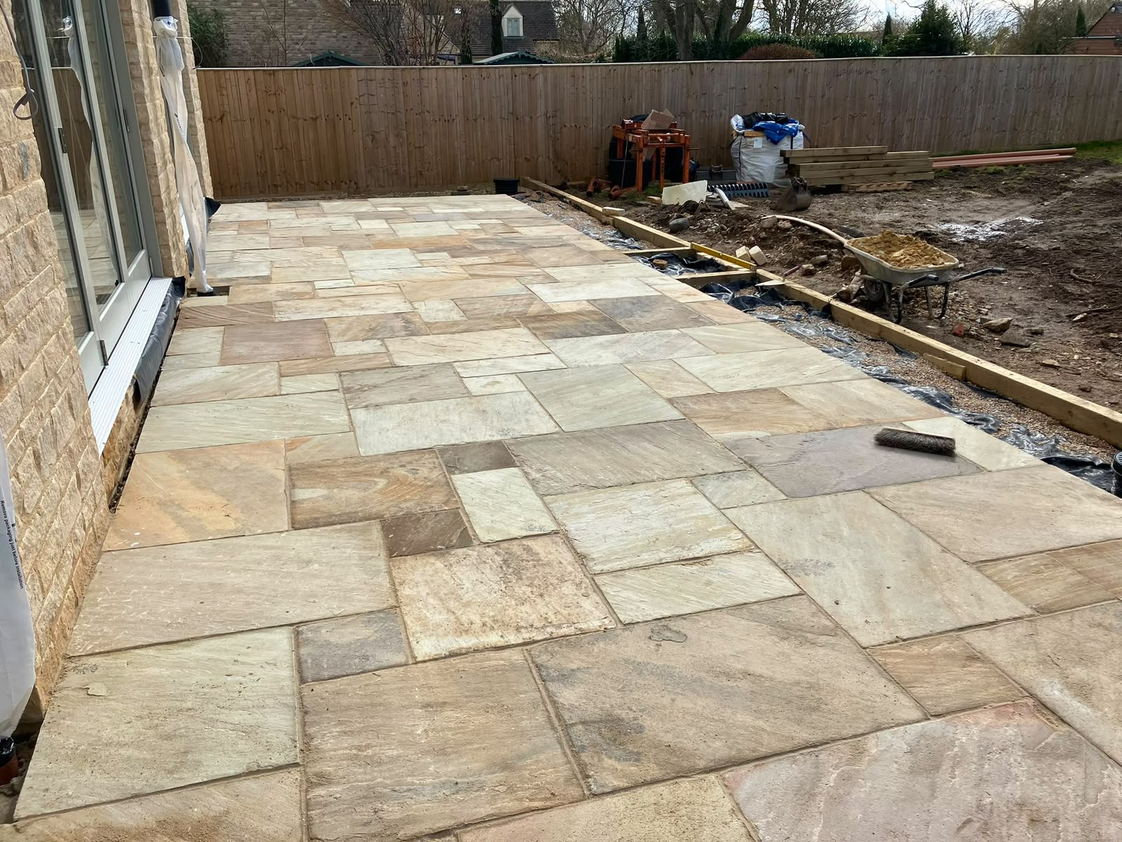 Patio installation underway by DR Smith Building hard landscapers.