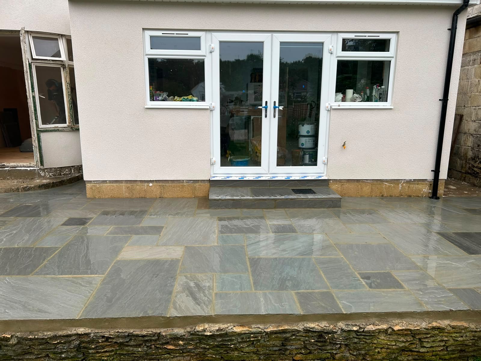 Completed sandstone patio with French doors by DR Smith Building, Wiltshire.