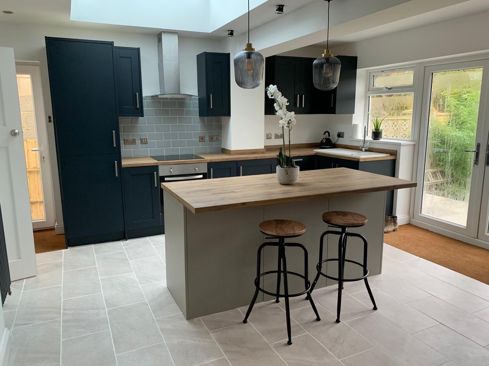 Finished open-plan kitchen with island by DR Smith Building extensions team.